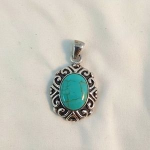Turquoise pendant inlaid in sterling silver filigree